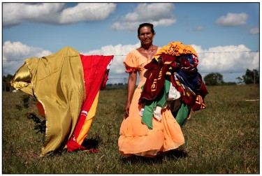 Cigana retira as roupas do varal em um acampamento. Foto: Marcio Lima